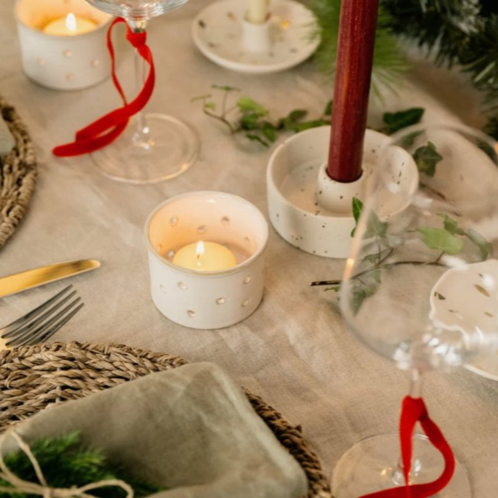 Figgy Pudding Scented Tealights shown lit on a festive table setting - Helen Round